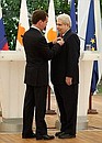 Dmitry Medvedev awards the Order of Friendship to President of Cyprus Demetris Christofias.