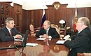 President Putin meeting with Prime Minister Mikhail Kasyanov and Central Bank Chairman Viktor Gerashchenko.
