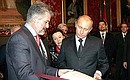 Manuel Marin Gonzales, President of the Spanish Congress of Deputies, hands over a copy of the Spanish Constitution to President Vladimir Putin.