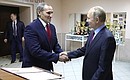 Vladimir Putin signs the distinguished visitors’ book. With Martial Arts Centre Director Yury Filimonov.