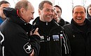 With Prime Minister Vladimir Putin and Silvio Berlusconi while reviewing the sledding and bobsleigh track.