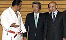 President Putin with Japanese Prime Minister Junichiro Koizumi (centre) and Olympic judo champion Yasuhiro Yamashita visiting a sports school.
