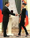 Dmitry Medvedev presents the certificate conferring the honorary title National Artist of Honour to ballerina Natalia Balakhnicheva.
