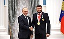 Presenting state decorations to winners of the 2020 Summer Paralympic Games in Tokyo. Paralympic wheelchair fencing champion Artur Yusupov receives the Order of Friendship. Photo: RIA Novosti