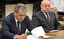 Before the meeting with permanent members of the Security Council. Defence Minister Sergei Shoigu (left) and Director of the Foreign Intelligence Service Mikhail Fradkov.
