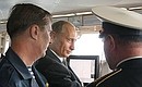 President Putin in the control cabin of the missile cruiser Marshal Ustinov during the Baltic and Northern Fleet tactical exercises. Left: Defence Minister Sergei Ivanov.