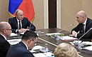 At a meeting with Government members. First Deputy Prime Minister and Finance Minister Anton Siluanov (right) delivers the main report.