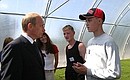 President Putin talking with senior formers working at the Vilga tree nursery.