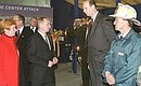 President Vladimir Putin and his wife, Lyudmila, meeting with people who displayed exceptional courage on 9/11-fire-fighters, rescuers, policemen and Russian journalist Yury Kirilchenko, 2nd to the right.