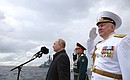 Before the beginning of the central part of the Main Naval Parade the Supreme Commander-in-Chief made the rounds of a parade line of military ships in the Kronstadt Yard and saluted the crews from the deck of a naval cutter. With Defence Minister Sergei Shoigu and Commander-in-Chief of the Russian Navy Nikolai Yevmenov.