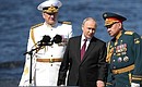 The Supreme Commander-in-Chief from a cutter reviewed fleet formations, lined up for the parade. With Defence Minister Sergei Shoigu and Commander-in-Chief of the Navy Nikolai Yevmenov (left).