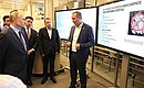 During a visit to the Regional Governance Centre outside Moscow. Inspection of stands showing the region’s digital solutions for urban management and communication with local residents.