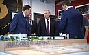 During his visit to the Datsyuk Arena sports complex, Vladimir Putin inspects a scale model of the sports and educational cluster to be constructed in Yekaterinburg's new neighbourhood.