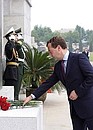 Laying flowers at the memorial to Soviet soldiers.