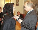 President Putin presenting state awards to citizens of Dagestan. Nurse Aishat Makkasharipova receiving the Order of Service to the Fatherland, 2nd Class.