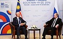 With Prime Minister of Malaysia Najib Razak. Photo: russia-asean20.ru