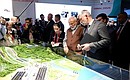 Prime Minister of India Narendra Modi and Minister of Transport Yevgeny Ditrikh, right, during a tour of the Far East Street exhibition.