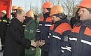 At the unveiling ceremony for a new section of Moscow\'s Third Ring Road. Vladimir Putin congratulates the builders on their achievement.