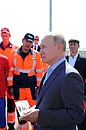 Vladimir Putin speaks with VAD workers who helped build the Taurida motorway.