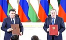Signing Russia-Uzbekistan documents. Photo: Artem Geodakyan, TASS