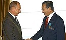 President Putin conferring the Order of Friendship on Malaysian Prime Minister Mahathir Mohamad.