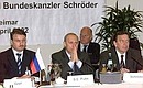 President Putin with German Chancellor Gerhard Schroeder and Russia\'s Economic Development and Trade Minister German Gref (left) at a meeting with Russian and German businessmen.