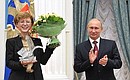Vladimir Putin presents the main prize – the Big Crystal Pelican – to Vita Kirichenko, a Russian language and literature teacher.