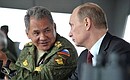 During the military exercises being held as part of the comprehensive troop inspection in the Eastern Military District. With Defence Minister Sergei Shoigu.