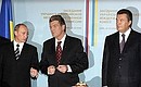 At a ceremony of signing Russian-Ukrainian documents with Ukrainian President Viktor Yushchenko (center) and Ukrainian Prime Minister Viktor Yanukovich.