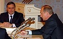 President Putin with Prime Minister Mikhail Kasyanov at a Security Council meeting on national border policy.