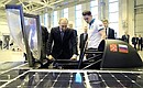 Vladimir Putin inspects a solar-powered electric car designed by a university team during his visit to Peter the Great St Petersburg Polytechnic University.