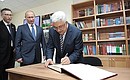 President of the Palestinian National Authority Mahmoud Abbas signs the distinguished visitors' book in the Russian Science and Culture Centre.