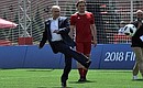 Vladimir Putin and Gianni Infantino start a friendly match between world football stars and young players from FC Totem Krasnoyarsk.