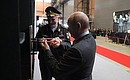During his visit to the Severnaya Verf Shipyard, Vladimir Putin and Navy veteran, Hero of the Russian Federation Vsevolod Khmyrov attach the storm board to the Admiral Amelko frigate.