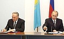 President Vladimir Putin and Kazakh President Nursultan Nazarbayev signing a joint statement.