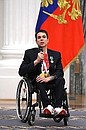Presenting state decorations to winners of the 2020 Summer Paralympic Games in Tokyo. Roman Zhdanov, who won three gold medals and two bronzes in swimming events at the Paralympics, receives the Order of Friendship. Photo: RIA Novosti