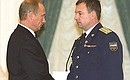 President Putin presenting the Star of Hero of Russia to Cosmonaut Yury Lonchakov.