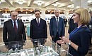 With Transport Minister Maxim Sokolov, centre, and Presidential Aide Andrei Belousov during a visit to the exhibition of priority transport projects.