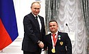 Presenting state decorations to winners of the 2020 Summer Paralympic Games in Tokyo. Paralympic athletics champion Denis Gnezdilov receives the Order of Friendship. Photo: RIA Novosti