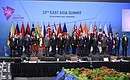 The leaders of the countries attending the East Asia Summit pose for a photo.