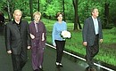President Vladimir Putin and his wife, Lyudmila, during a walk with US President George Bush and his wife, Laura.