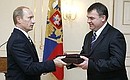 Handing to Defence Minister Anatoly Serdyukov the Gold Star medal and Hero of Russia certificate and document bestowed on Soviet intelligence officer George Koval.