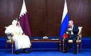 With Emir of Qatar Sheikh Tamim bin Hamad Al Thani. Photo: Vyacheslav Prokofyev, TASS
