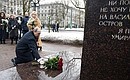 Vladimir Putin lays flowers at the monument to Anatoly Sobchak.