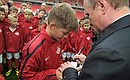 Visiting the new Otkrytiye Arena stadium. With children studying at the Spartak Children’s Football Academy. Vladimir Putin signed a football and had his photo taken with the young players.