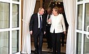 Vladimir Putin and German Federal Chancellor Angela Merkel upon the completion of the joint news conference.
