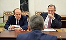 Before a meeting with permanent Security Council members. Director of the Federal Security Service Alexander Bortnikov (left) and Foreign Minister Sergei Lavrov.