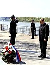 President Putin laying flowers at a monument to sunken ships of the Caspian Flotilla.