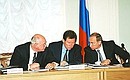 At a meeting of the state commission to prepare for celebrations of St Petersburg\'s 300th anniversary with Governor of Saint Petersburg Vladimir Yakovlev and Economics Minister Andrei Shapovalyants (left).