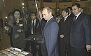 President Putin looking at the exhibition of Kazakh national currency.